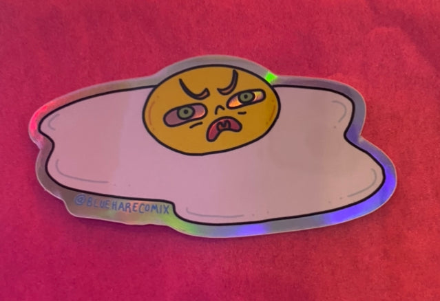 CAN I OFFER YOU A NICE EGG IN THESE TRYING TIMES Sticker by Blue Hare Comix