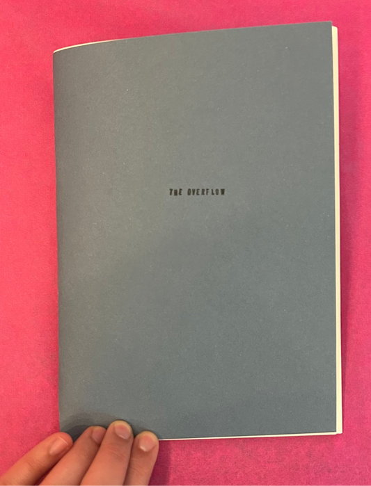 Gray notebook with 'The Overflow' text on a pink background

